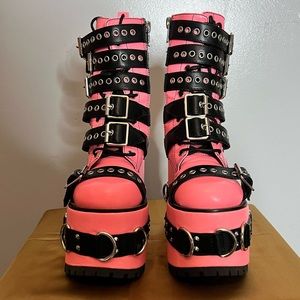Neon pink platform boots.
